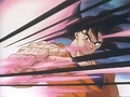 Goku deflects a ki blast in Plan to Eradicate the Saiyans