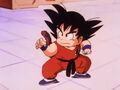 Goku takes a battle stance after dodging Nams kick