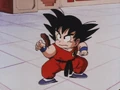 Goku takes a battle stance after dodging Nams kick