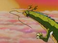 Goku and Shenron flying over the sunset