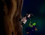 An injured Piccolo attempts to attack Turles