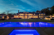 The night time with swimming pool and spa back view of the Spencer House
