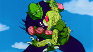 Piccolo punches a Saibaman in the stomach