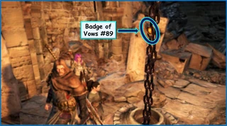 Fig. 2: Badge of Vows #47 is stuck inside the links of a large chain. It will have to be shot down or dislodged through other means such as magic.