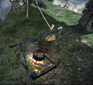 Badge within the cooking fire (bottom corner)