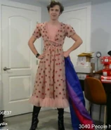 Eret wearing the strawberry dress with the Bisexual flag