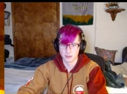 Antfrost with pink hair wearing Velvet's merch