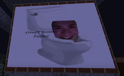 The image of George on the toilet's tank