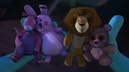 A Dragon peluche from Shrek 2, a Alex peluche from Madagascar, and a teddy bear from Over the Hedge appears in Susan Murphy's room. (Night of the Living Carrots)