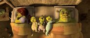 Shrek being woken up by his children