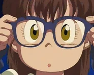 Arale trying on glasses