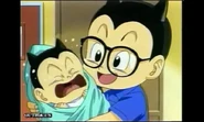 In the arms of his father Obotchaman.