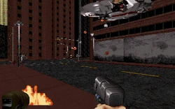 95-08May21.22.43.44-01.jpg (90 KB) Score, May 21, 1995 @ 22:43:44. RPV piloted by an Enforcer and firing explosives on L6, between the building that would become the club (right) and adult-themed store (behind the camera) on Red Light District