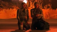 Jessica and Paul in stillsuits with fremkit, Paul checking paracompass (Frank Herbert's Dune miniseries, 2000)