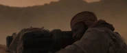 Jamis aiming a heavy lasgun from cover, during a Fremen evening ambush of Harkonnen harvesters and carryalls (Dune, 2021)