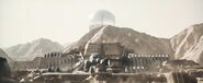 Emperor Shaddam IV's personal flagship hovering above the governor's palace of Harkonnen-held Arrakeen (Dune: Part Two, 2024)