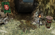 Zaurask banner and tribal totem in front of a cave entrance in southern Utrae's coastal bluffs