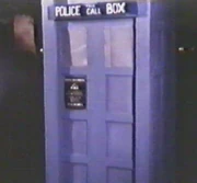 Exterior (The Wrath of Eukor), with oversized "Police Box" sign and a lack of windows.