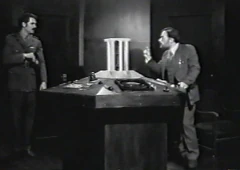 The Doctor and Colonel Harvey at the console.