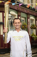 Billy Mitchell holding the Olympic Torch