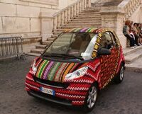 A yarn bombed Smart car