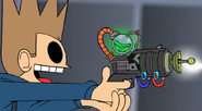 Tom shooting with a gun similar to the one Future Edd used in WTFuture