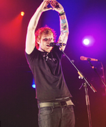 Ed Sheeran holds up heart while performing