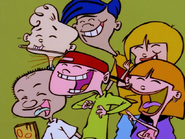 The kids notice something funny. (Goof: Rolf's teeth are white instead of green.)