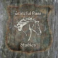 The Grateful Pass Stables sign
