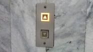 1980s Mitsubishi square call buttons with illuminating halo.