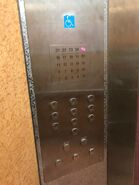 This Mitsubishi car operating panel for wheelchair uses a keypad configuration where passenger enter his/her destination floor. The registered floor number on the display above will light up, and will go off when the elevator has reached that floor.