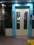 Mitsubishi elevator in Tokyo, Japan with center opening door equipped with partial window.