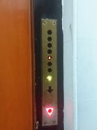 1960s Schindler hall station with triangle touch sensitive button (Red for down).