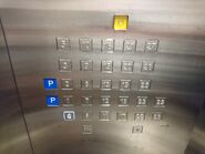 An elevator button panel skipped 4th floor and the Chinese unlucky number 14 and 24.