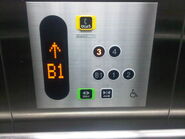 Modern day Toshiba elevator in Japan with a handicap panel. This panel is directly mounted on the cab side wall.
