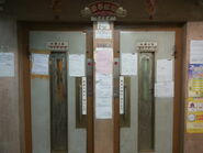 Schindler manual doors with scissor gate elevator in Hong Kong.
