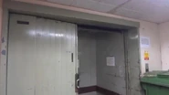 An old gated Bennie freight elevator with scissor gates.
