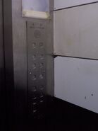 Stainless steel US89 series barrel button on a Schindler elevator car station.