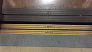 Otis door sill with 3 lines next to Otis text on an elevator from c. 1952 (two logos on inside, center opening doors)