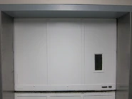 Top vertical bi-parting hoistway door