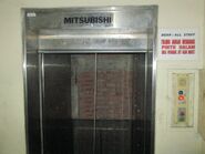 1990 Mitsubishi dumbwaiter with it's door opened, revealing it's shaft wall.