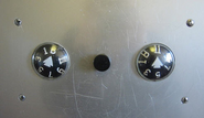 Vintage Otis no arrow black button hall station with Rotodial floor indicators.