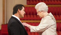 Queen Elizabeth II presents David Braben with his OBE