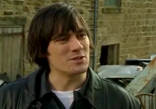 Cain's first arrives in the village in March 2000