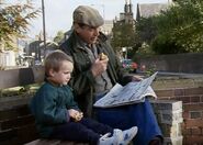 A three year old Robert sits with his father. November 1989.