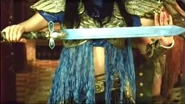 As seen in the teaser for the show, the warrior armor of Amihan’s Descendant is like Amihan’s warrior armor in Etheria. The only differences are that the sleeves are short and is made out of a different material than Amihan’s, the headgear, short wings, breastplate, belt and gauntlets are colored gold, the stomach is only partially covered by two short under clothing, the back of the legs have short blue fabric, and she wears a light blue cape.