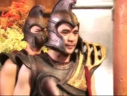 In his warrior armor wearing his helmet.