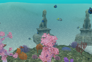 Two of the "Ancient Statue" decorations sitting in the sand.