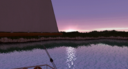 A sunrise over Manoa Lai. The sail of the Gabbiano can be seen.