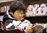 Young boy reading manga